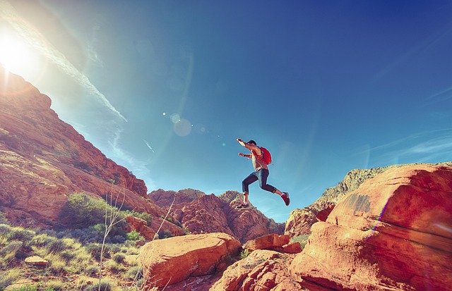 Person jumping across rocks symbolizing transformation in the Breaking the Habit of Being Yourself 21-Day Formula.