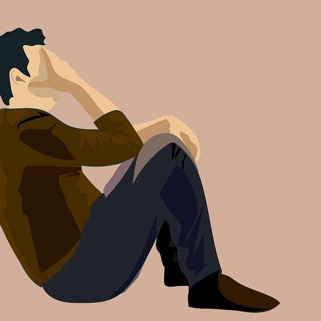 Sad Face: 5 Emotional Causes You Should Know – man sitting alone feeling stressed and emotionally overwhelmed.
