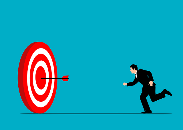 Businessman running toward a red target with an arrow, illustrating career opportunities and setting goals to choose the right career path.