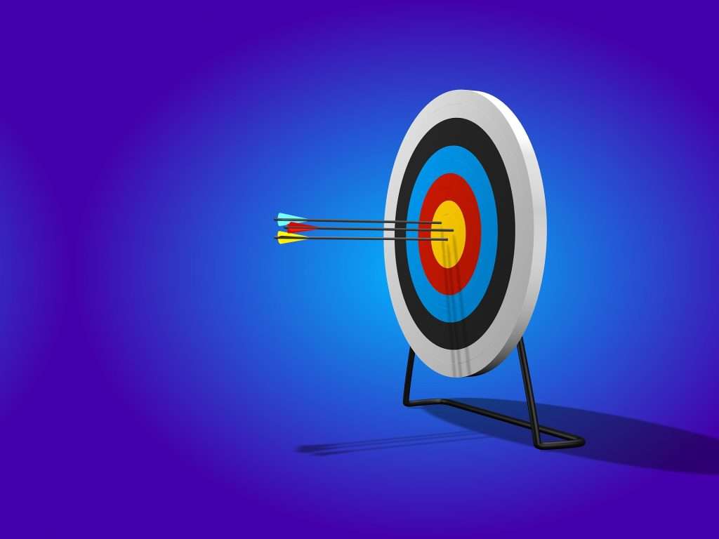 Archery target with three arrows in the bullseye representing focused goal setting under the 10X Rule.