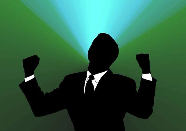Silhouette of a confident professional raising fists in victory symbolization of self-assertiveness and high self-confidence