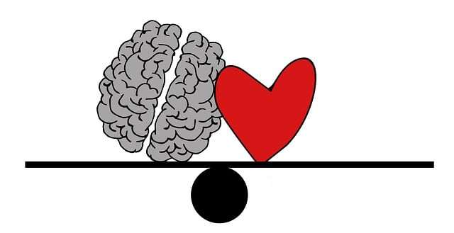 Illustration of a brain and heart balanced on a seesaw representing emotional balance and overcoming anxiety.