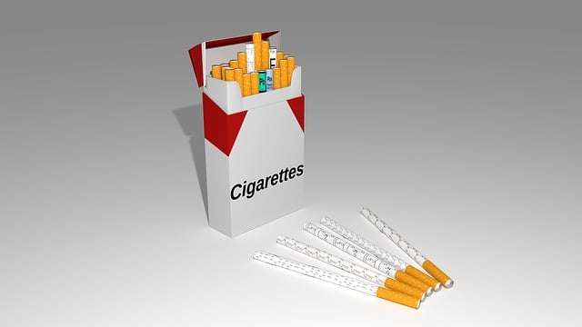 An open cigarette pack next to loose cigarettes, illustrating ways to stop smoking.